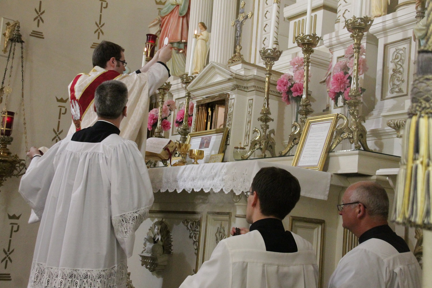 Father Dylan Schrader elevates the Most Blessed Sacrament during a Mass in Latin in the Extraordinary Form in St. Joseph Church in Westphalia.